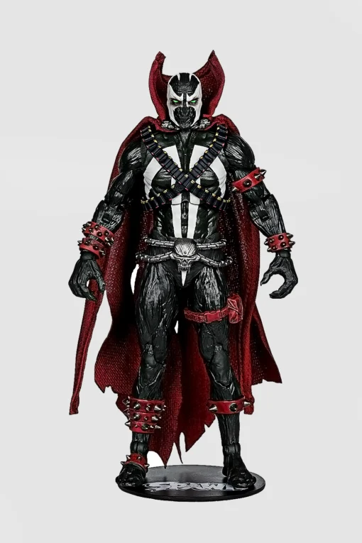 Front view of an action figure in black and white armor with a red cape.